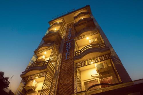 a tall building with lights on it at night at Chautari Boutique Hotel in Pokhara