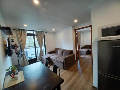 a living room with a table and a couch at Gabs CozyHomes at MegaTower IV Condo, City Center Baguio in Baguio