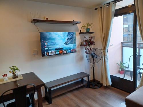 a living room with a flat screen tv on the wall at Gabs CozyHomes at MegaTower IV Condo, City Center Baguio in Baguio