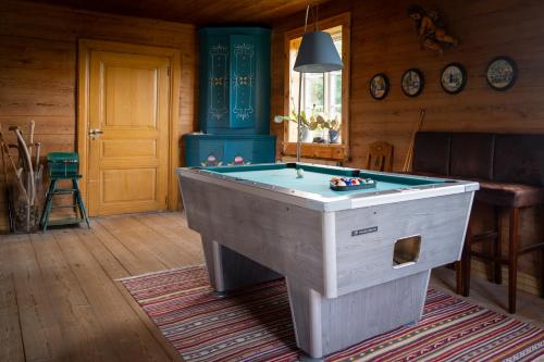 a room with a pool table in a house at La Maison Rouge de Slätten Bed and Breakfast in Vilshult