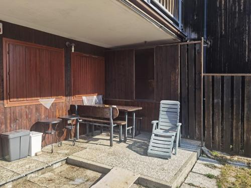 a patio with a table and two chairs and a piano at Il giardino sulle Piste in Prato Nevoso