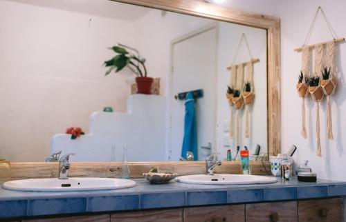 a bathroom with two sinks and a large mirror at Tree Lodge Mauritius Villa in Argy