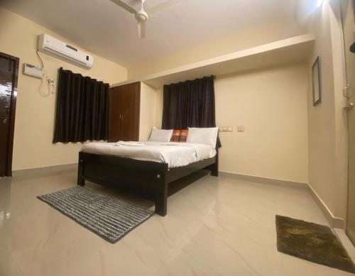 a bedroom with a bed and a window and a rug at The waves in Chennai