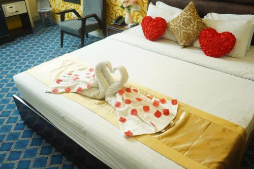 a hotel room with two beds with hearts on them at Grand Mostafa Hotel Ababil in Sylhet
