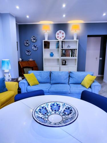 a living room with a blue couch and a table at La casa dei ricordi in Cagliari