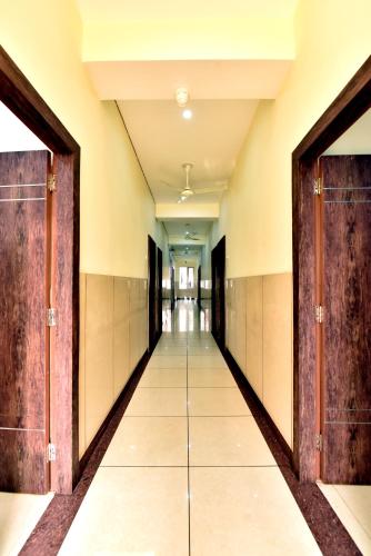 an empty corridor with doors in a building at Royal Inn Jammu in Jammu