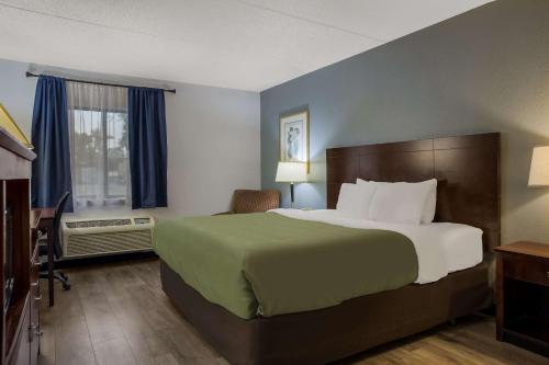 a hotel room with a large bed and a window at Quality Inn in Toledo