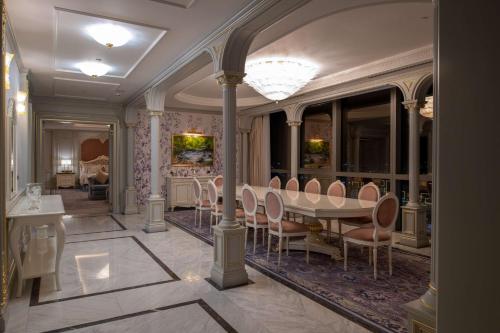 a dining room with a table and chairs at Hilton Tashkent City in Tashkent