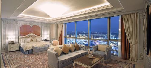 a bedroom with a bed and a large window at Hilton Tashkent City in Tashkent