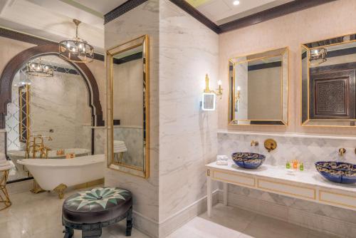 a bathroom with a tub and a sink and a bath tub at Hilton Tashkent City in Tashkent