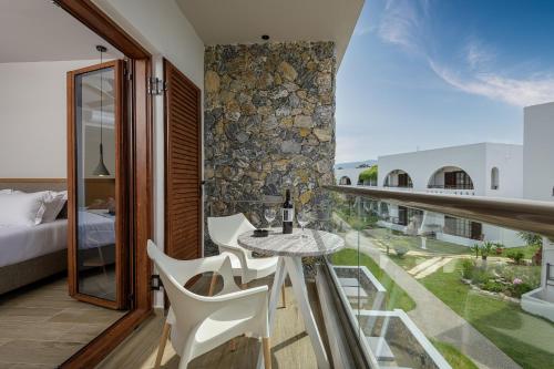 a room with a balcony with a table and chairs at Gaia Garden in Kos Town