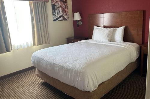 a bedroom with a large bed in a hotel room at Executive Suites in Pickerington