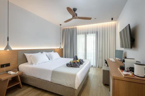 a bedroom with a bed and a desk with a computer at Gaia Garden in Kos Town