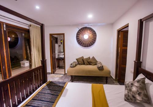 a bedroom with a bed and a mirror at Beachside Pool Villa - Karthiyayini by VOYE HOMES in Turavūr