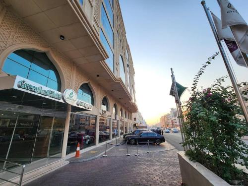 a building with a car parked in front of a street at فندق جرين ليف in Jeddah