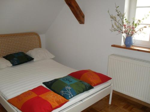 a bed with two pillows on it in a room at Ferienhaus Duhra in Peitz