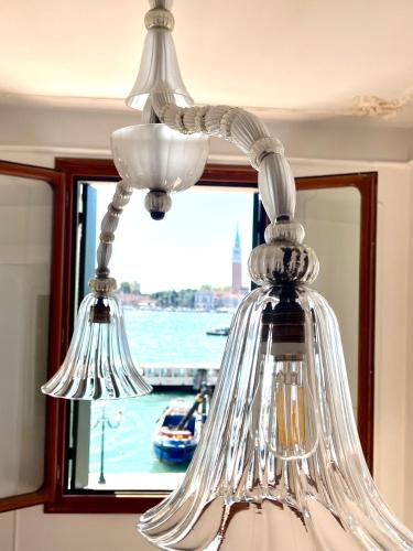 a glass chandelier hanging in front of a window at The B Collection - San Marco Riva schiavoni in Venice