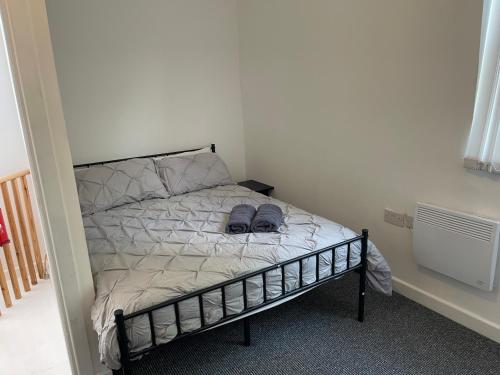 a bedroom with a bed with two shoes on it at Humber Maisonette Airy, Modern & Chic! in Goole