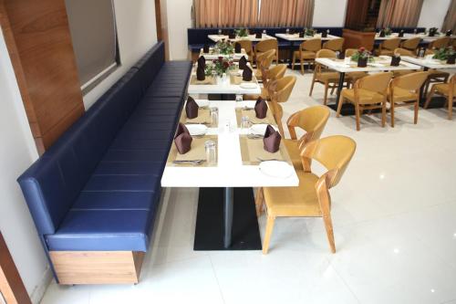 a row of tables and chairs in a restaurant at Lords Eco Inn, Ambaji in Ambaji