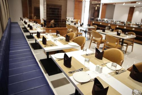 a row of tables and chairs in a restaurant at Lords Eco Inn, Ambaji in Ambaji