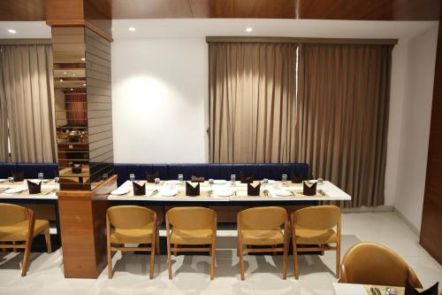 a dining room with a large table and chairs at Lords Eco Inn, Ambaji in Ambaji