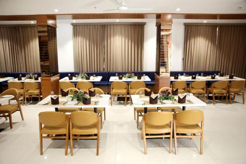 a dining room with tables and chairs in a room at Lords Eco Inn, Ambaji in Ambaji