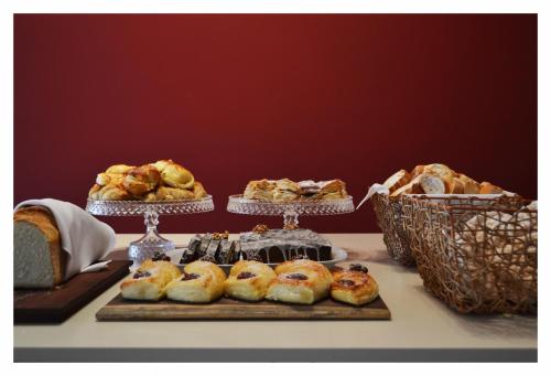 a table with several different types of pastries and bread at La Campiña Club Hotel & Spa in Santa Rosa