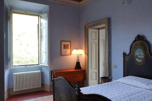 Postel nebo postele na pokoji v ubytování Palazzo Augusto