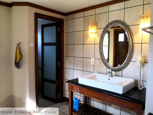 a bathroom with a sink and a mirror at ALPINE GLX PD Port Dickson in Port Dickson