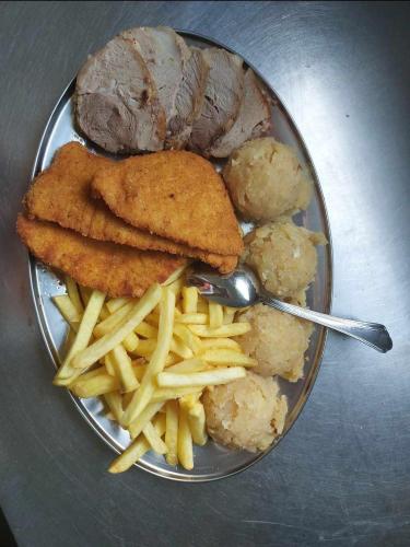 a plate of food with meat and french fries at Turistično - Izletniška kmetija Žerjav in Brežice