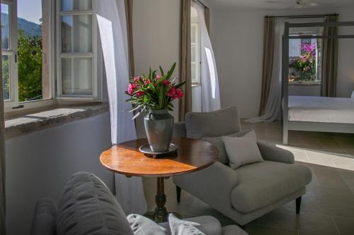 a living room with a vase of flowers on a table at Revelin Hvar in Stari Grad