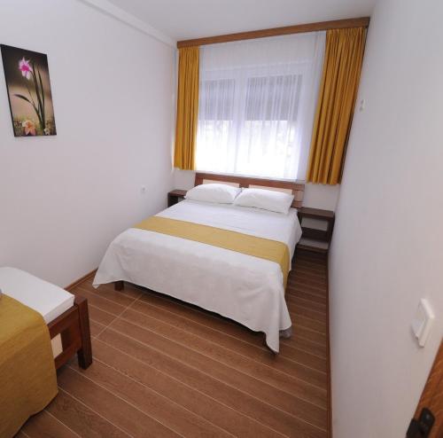 a hotel room with two beds and a window at Hotel Rafaelo in Bosanska Dubica