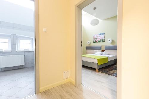 Postel nebo postele na pokoji v ubytování Antonińska Hotel & Apartamenty