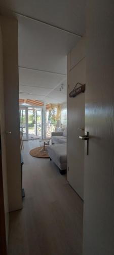 a living room with a couch and a table at Strandhuisje in Voorthuizen