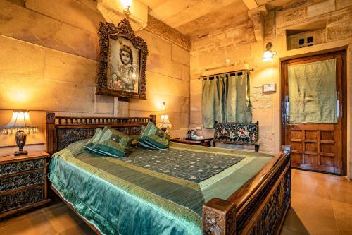 a bedroom with a large bed in a room at Hotel Garh Jaisal Haveli in Jaisalmer