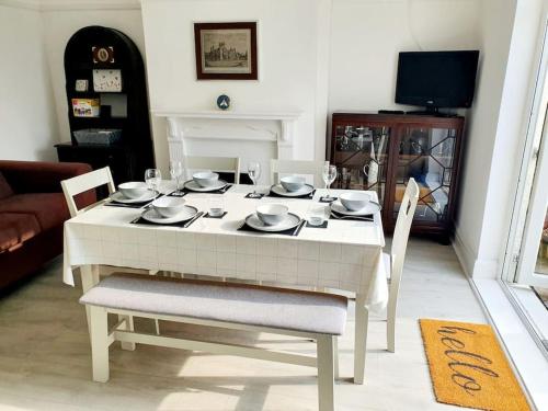 a white table and chairs in a living room at Fabulous family house next to the beach in Nottage