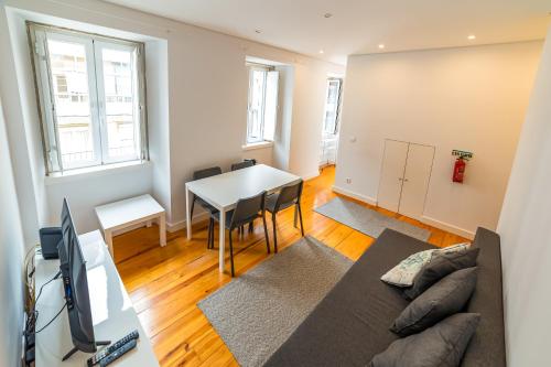 a living room with a couch and a table at Golden Place - Cacilhas in Almada
