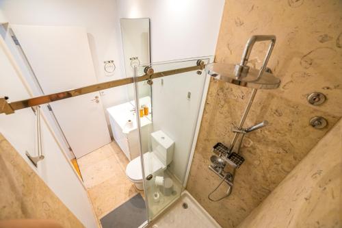 a bathroom with a shower with a toilet at Golden Place - Cacilhas in Almada