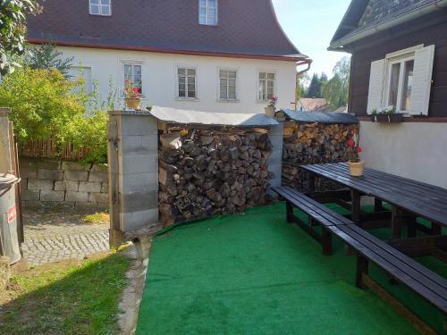 a backyard with a picnic table and a green lawn at Chalupa u kostela pro 9 in Chřibská