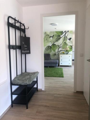 a living room with a black shelf and a couch at Apartments "Am Ardetzenberg" in Feldkirch