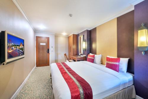 a bedroom with a large bed in a room at Nasa Bangkok in Bangkok