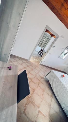 a room with a bed and a table and a floor at B&B Casale Pietrantica Tropea in Ciaramiti