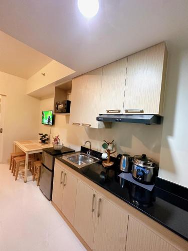 a kitchen with a sink and a counter top at Luxury Suites at Brenthill Baguio City in Baguio