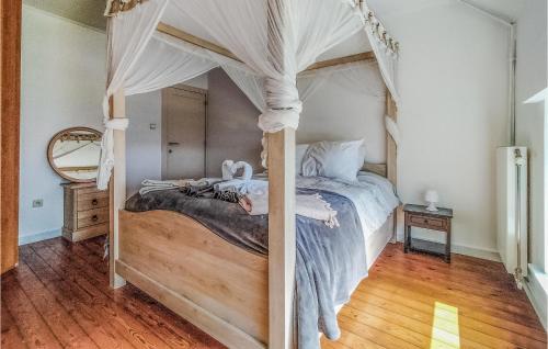 a bedroom with a canopy bed with stuffed animals on it at De Lindenhoeve in Sint-Katelijne-Waver