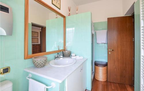 a bathroom with a sink and a mirror at Nice Apartment In Rogno With Outdoor Swimming Pool, Wifi And 1 Bedrooms in Rogno