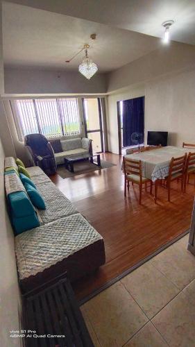 a living room with a table and a dining room at Splendido Tagaytay Taal Lake Staycation Free Parking Netflix No Free Pool in Tagaytay