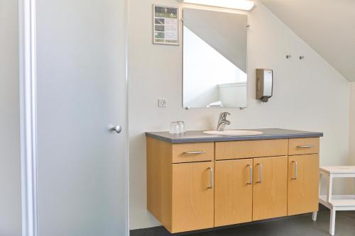 a bathroom with a sink and a mirror at Vejlsøhus Hotel and Conference Center in Silkeborg