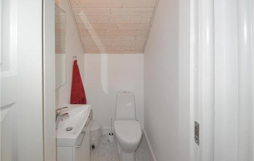 a white bathroom with a toilet and a sink at Shjlandet in Gjern