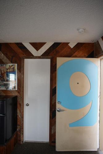 a room with a door with a smile painted on it at Huntington Surf Inn in Huntington Beach