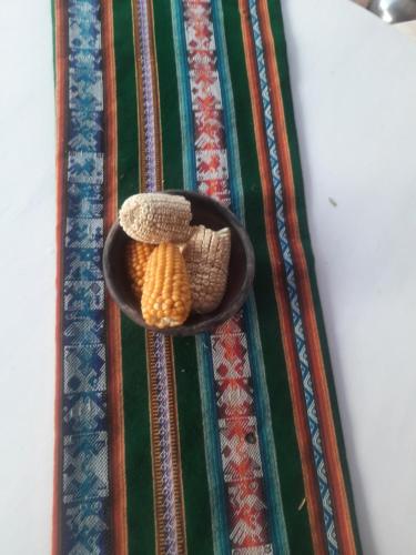 a bowl of corn and kernels on a rug at Hostal Katarpe in San Pedro de Atacama